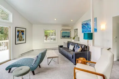 a living room with a couch and chairs at Lakefront Otis Home with Stunning Views and Boats! in Otis
