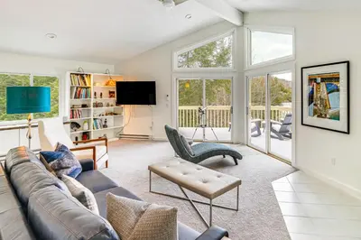 a living room with a couch and a tv at Lakefront Otis Home with Stunning Views and Boats! in Otis