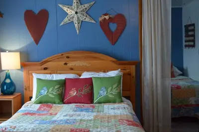 a bedroom with a bed with hearts on the wall at The Bavarian Manor Hotel in Purling