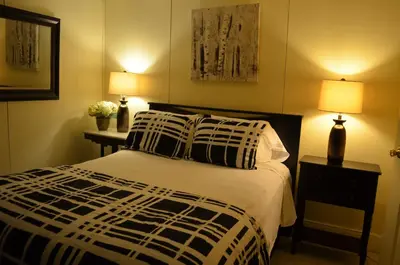 a bedroom with a bed with two lamps and two tables at The Bavarian Manor Hotel in Purling