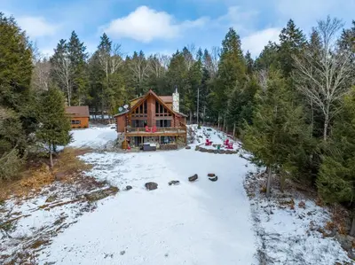 an aerial view of a log cabin in the snow at Beautiful Chalet, mins to Hunter/Windham slopes in Jewett