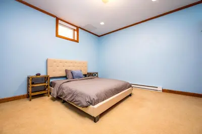 a bedroom with a bed in a blue room at Beautiful Chalet, mins to Hunter/Windham slopes in Jewett