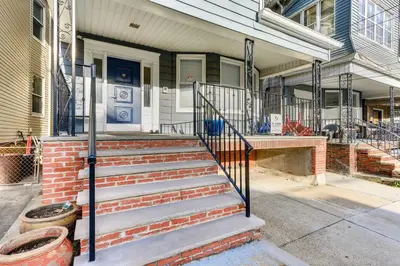 a house with stairs leading to the front door at Jersey City Vacation Rental Near Light Rail! in Jersey City