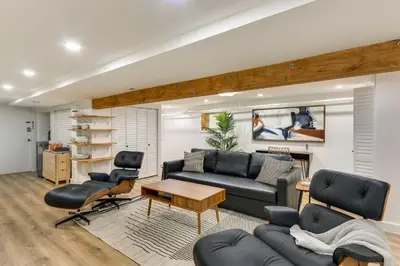a living room with a couch and a table and chairs at Jersey City Vacation Rental Near Light Rail! in Jersey City