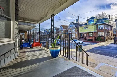 a porch of a house with a vase on it at Jersey City Apartment Near Liberty State Park in Jersey City
