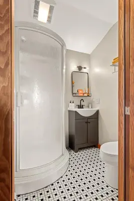 a bathroom with a shower and a toilet and a sink at Stella Firma in Bloomville