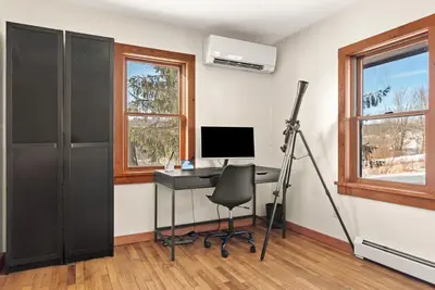 a room with a desk with a computer and a chair at Stella Firma in Bloomville