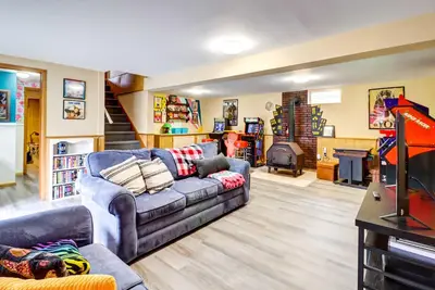 a living room with a couch and a fireplace at Pet-Friendly Home with Deck at Big Bass Lake! in Gouldsboro