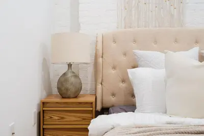 a bedroom with a bed with a lamp on a night stand at 1288-4R Newly furnished Prime UES 2BR in New York