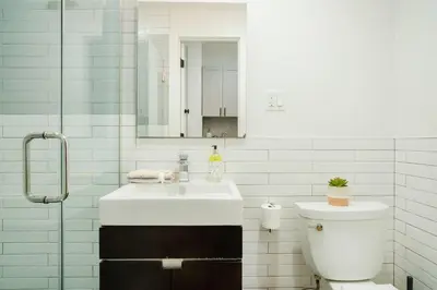 a white bathroom with a sink and a toilet at 1288-4R Newly furnished Prime UES 2BR in New York