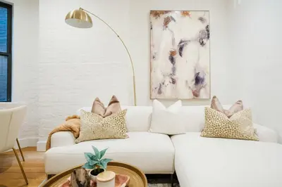 a living room with a white couch with pillows at 1288-4R Newly furnished Prime UES 2BR in New York