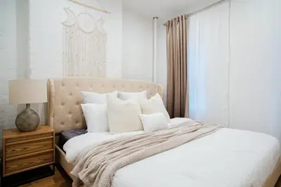 a bedroom with a bed with white sheets and pillows at 1288-4R Newly furnished Prime UES 2BR in New York