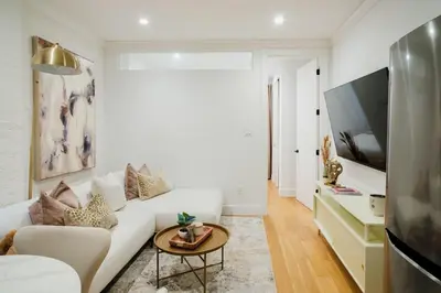 a living room with a white couch and a table at 1288-4R Newly furnished Prime UES 2BR in New York