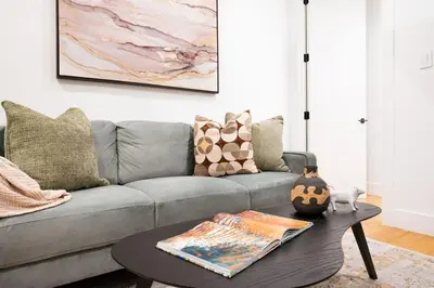 a living room with a gray couch and a table at 1288-3RS New Renovated 2 Bedrooms in New York