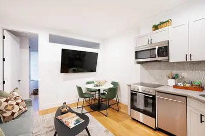 a kitchen and living room with a table and chairs at 1288-3RS New Renovated 2 Bedrooms in New York