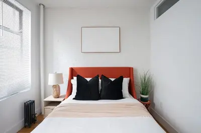 a bed with an orange headboard in a bedroom at 1288-3RS New Renovated 2 Bedrooms in New York
