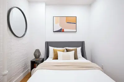 a bedroom with a bed and a mirror at 1288-3RS New Renovated 2 Bedrooms in New York