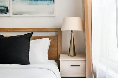 a bedroom with a bed with a lamp on a night stand at 39-2 Renovated 3BR Prime Hudson Yards Area in New York