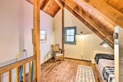a bedroom with a bed and a wooden floor at Berkshires Getaway Less Than 1 Mi Skiing and Hiking! in Shelburne Falls