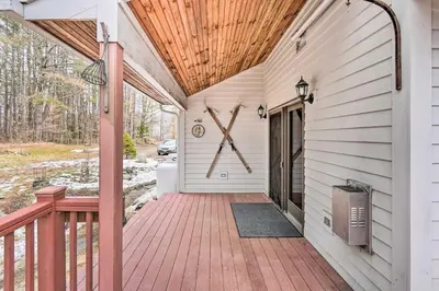 a porch with a wooden deck with a large x on it at Berkshires Getaway Less Than 1 Mi Skiing and Hiking! in Shelburne Falls