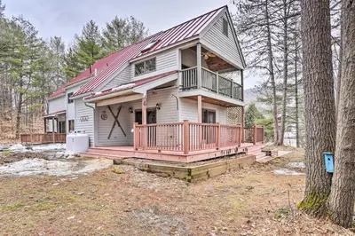 a large house with a porch and a deck at Berkshires Getaway Less Than 1 Mi Skiing and Hiking! in Shelburne Falls