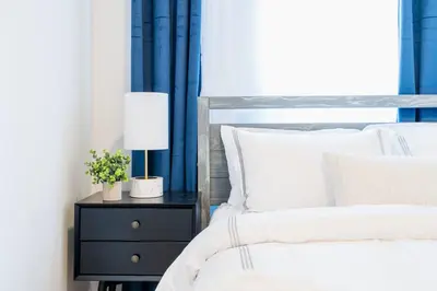 a bed with white sheets and a lamp on a night stand at 1435-4 I 3 Bedrooms 2Bath W D Prime Upper east in New York