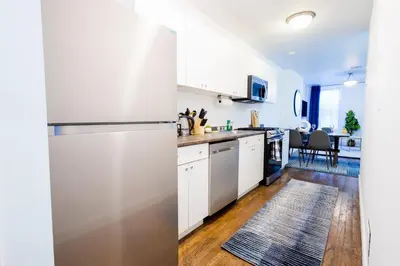 a kitchen with white cabinets and a stainless steel refrigerator at 1435-2 3 Bedrooms 2Bath W D UES in New York