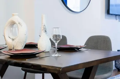 a dining table with glasses and plates and chairs at 1435-2 3 Bedrooms 2Bath W D UES in New York