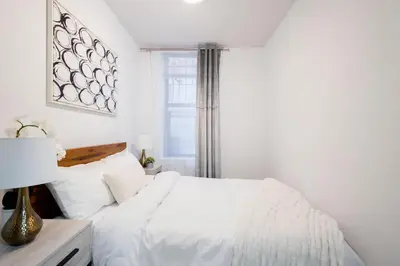 a bedroom with a white bed and a window at 1435-2 3 Bedrooms 2Bath W D UES in New York