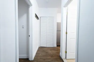 a hallway with white doors and wood floors at 1435-2 3 Bedrooms 2Bath W D UES in New York