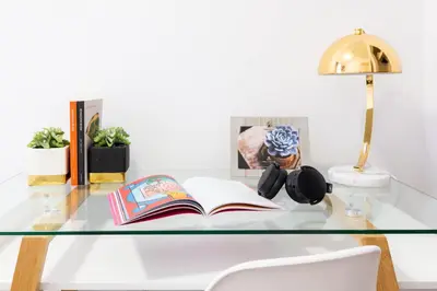 a glass table with a book and a lamp on it at 1435-2 3 Bedrooms 2Bath W D UES in New York