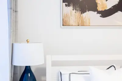 a bedroom with a blue lamp and a painting on the wall at 1435-2 3 Bedrooms 2Bath W D UES in New York