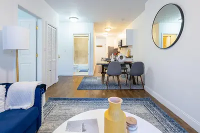 a living room with a blue couch and a table at 1435-2 3 Bedrooms 2Bath W D UES in New York