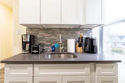 a kitchen counter with a sink and a window at Upscale Relax 2 Bedroom near Yankee Stadium 14 min drive in New Rochelle