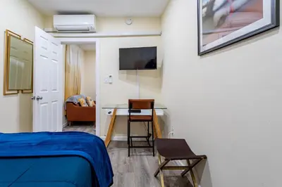a bedroom with a bed and a desk and a chair at Upscale Relax 2 Bedroom near Yankee Stadium 14 min drive in New Rochelle