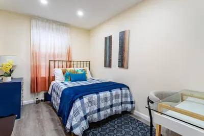 a small bedroom with a bed and a window at Upscale Relax 2 Bedroom near Yankee Stadium 14 min drive in New Rochelle
