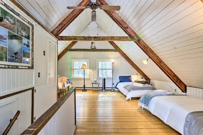 a attic bedroom with two beds and a ceiling at West Cornwall Cabin about 4 Mi to Covered Bridge! in West Cornwall