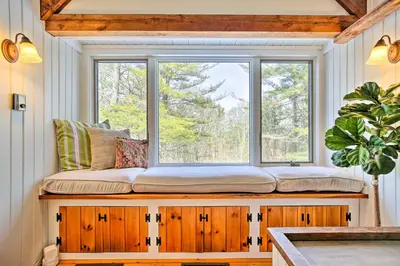 a window seat in a kitchen with a large window at West Cornwall Cabin about 4 Mi to Covered Bridge! in West Cornwall