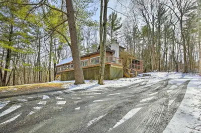 a house on the side of a road in the woods at West Cornwall Cabin about 4 Mi to Covered Bridge! in West Cornwall