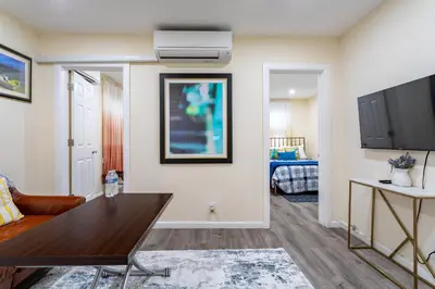 a living room with a couch and a table at Luxe Retreat 2 Bedroom Hideaway Minutes from NYC in New Rochelle