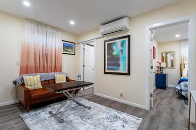 a living room with a couch and a table at Luxe Retreat 2 Bedroom Hideaway Minutes from NYC in New Rochelle