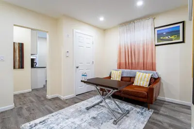 a living room with a couch and a table at Luxe Retreat 2 Bedroom Hideaway Minutes from NYC in New Rochelle