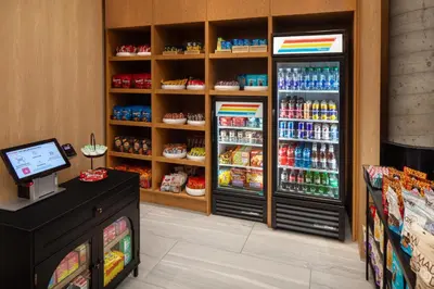 a grocery store with two refrigerators in a store at Home2 Suites By Hilton New York Times Square in New York