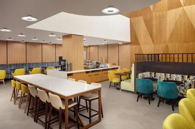 a dining room with a table and chairs at Hampton Inn by Hilton New York Times Square in New York