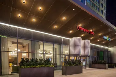 a store front of a building with plants in front at Hampton Inn by Hilton New York Times Square in New York