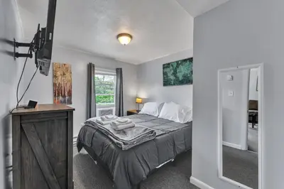 a bedroom with a large bed and a window at Babe Ruth Apt 2 All Star Baseball Rentals in Oneonta