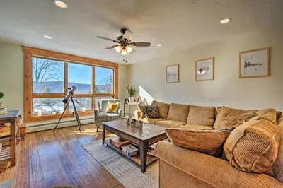 a living room with a couch and a table at Idyllic Mount Snow Condo with View and Amenities! in West Dover