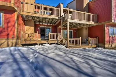 a house with a deck in the snow at Idyllic Mount Snow Condo with View and Amenities! in West Dover
