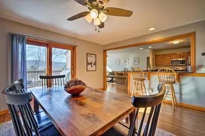 a dining room with a wooden table and a ceiling fan at Idyllic Mount Snow Condo with View and Amenities! in West Dover