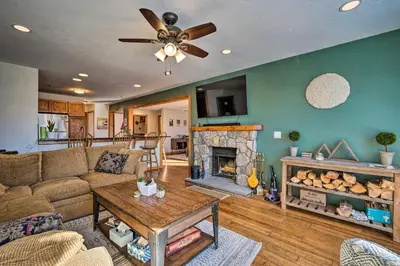 a living room with a couch and a fireplace at Idyllic Mount Snow Condo with View and Amenities! in West Dover